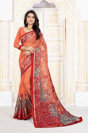 For Your Semi-Casuals, Grab This Pretty Printed Saree In Orange Color Paired With Orange Colored Blouse. This Saree Is Fabricated On Chiffon Brasso Paired With Art Silk Fabricated Blouse. It Is Light Weight And Easy To Carry All Day Long. 