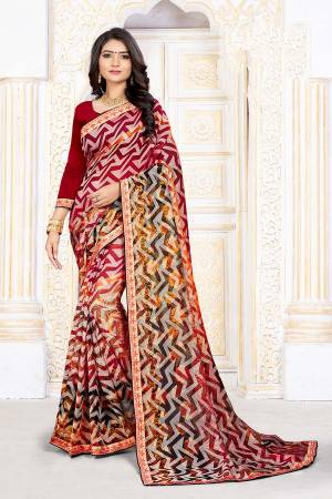 For Your Semi-Casuals, Grab This Pretty Printed Saree In Red And Multi Color Paired With Multi Colored Blouse. This Saree Is Fabricated On Chiffon Brasso Paired With Art Silk Fabricated Blouse. It Is Light Weight And Easy To Carry All Day Long. 
