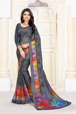 Lokk Pretty In This Dark Grey Colored Saree Paired With Dark Grey Colored Blouse. This Saree Is Fabricated On Chiffon Brasso Paired With Art Silk Fabricated Blouse. Its Fabrics Are Soft Towards Skin And Durable. 