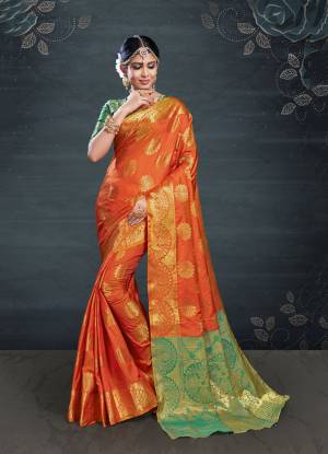 Enhance Your Personality In This Lovely Silk Based Designer Saree In Orange Color Paired With Contrasting Green Colored Blouse. This Saree And Blouse Are Fabricated On Banarasi Art Silk Which Gives A Rich Look To Your Personality. 