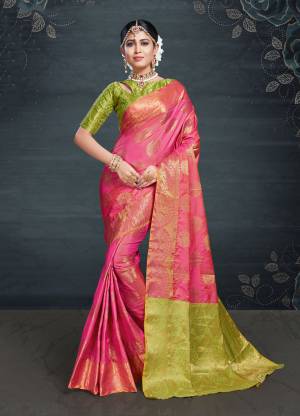 Look Pretty In This Silk Based Saree In Pink Color Paired With Contrasting Parrot Green Colored Blouse. This Saree And Blouse Are Fabricated On Banarasi Art Silk Beautified With Weave All Over. 