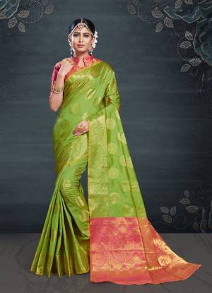 Celebrate This Festive Season With Beauty And Comfort Wearing This Designer Saree In Green Color Paired With Contrasting Pink Colored Blouse. This Saree And Blouse Are Fabricated On Banarasi Art Silk Beautified With Weave All Over. It Is Light Weight And Easy To Drape. 