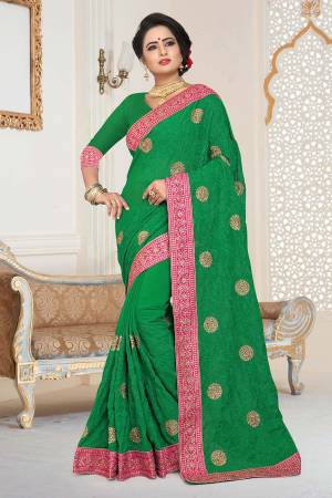 Grab This Beautiful Heavy Designer Saree In Green Color Paired With Green Colored Blouse. This Saree And Blouse are Fabricated On Georgette Beautified With Jari And Tone To Tone Resham Embroidery With Stone Work.  Buy This Saree Now. 