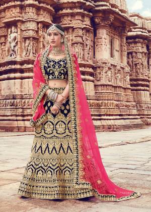 Ditch The Trend Of Pink And Red In Bridal Wear With This Heavy Designer Lehenga Choli In Navy Blue Color Paired With Contrasting Pink Colored Dupatta. This Lehenga Choli Is Velvet Based Paired With Net Fabricated Dupatta. Its Unique Color And Heavy Embroidery Will Give An Attractive Look To Your Personality.