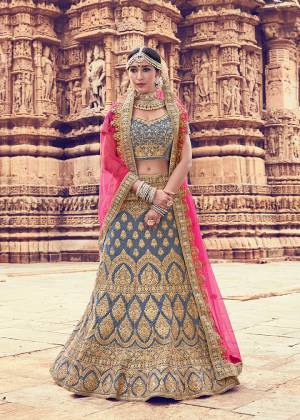 Escape The Ordinary With This New And Unique Color Pallete In Bridal Lehenga Choli In Grey Color Paired With Contrasting Pink Colored Dupatta. Its Heavy Embroidered Lehenga And Blouse are Fabricated On Velvet Paired With Net Fabricated Dupatta. Buy This Lehenga Choli And Create A New Trend In Bridal Wear. 