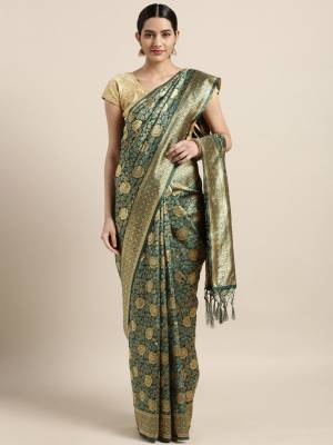 Grab This Pretty Silk Based Saree With Heavy Weave In Teal Green Color Paired With Beige Colored Blouse. This Saree and blouse are Blouse Fabricated On Tanchoi Art Silk Beautified With Weave All Over. It Is Light Weight And Easy To Carry All Day Long.