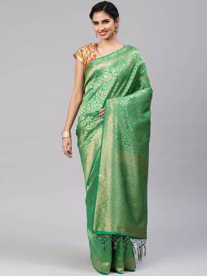 Celebrate This Festive Season In Traditional Look Wearing This Silk Based Saree In Green Color. This Saree And Blouse are Fabricated On Banarasi Art Silk Beautified With Weave All Over