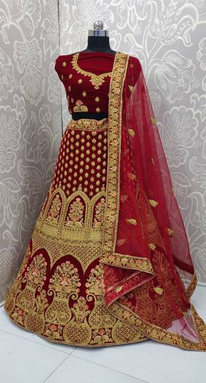 Here Is A Very Beautiful And Heavy Bridal Designer Lehenga Choli In Maroon Color. Its Blouse And Lehenga Are Fabricated On Velvet Paired With Net Fabricated Dupatta. It Is Beautified With Heavy Embroidery Which Gives An Attractive Look To It.