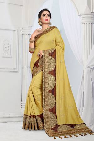Get Ready For The Upcoming Wedding And Festive Season With This Designer Saree In Yellow Color Paired With Contrasting Brown Colored Blouse. This Embroidered Saree Is Fabricated On Vichitra Silk Paired With Tafeta Art Silk Fabricated Blouse. 