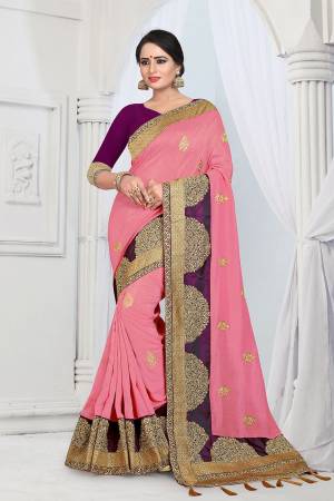 Get Ready For The Upcoming Wedding And Festive Season With This Designer Saree In Pink Color Paired With Contrasting Purple Colored Blouse. This Embroidered Saree Is Fabricated On Vichitra Silk Paired With Tafeta Art Silk Fabricated Blouse. 