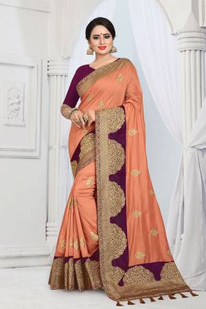Get Ready For The Upcoming Wedding And Festive Season With This Designer Saree In Dark Peach Color Paired With Contrasting Purple Colored Blouse. This Embroidered Saree Is Fabricated On Vichitra Silk Paired With Tafeta Art Silk Fabricated Blouse. 