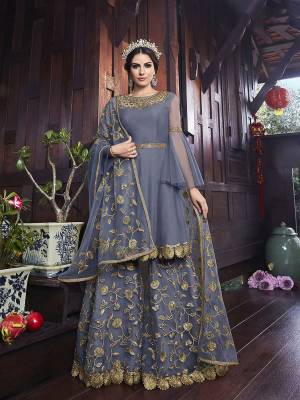 Follow The Trend With This Designer Heavy Sharara Suit In Dark Grey Color. Its Embroiderd Top, Bottom And Dupatta Are Fabricated On Net Which Comes With Art Silk Fabricated Inner. 