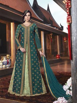 Style This Lovely Dress In Two Ways As It Comes With A Jacket As Well As Gown. This Ind-Western Dress In Shades Of Green Has A Beautiful Embroidered Gown Fabricated On Net Paired With Art Silk Embroidered Pants And Net Fabricated Dupatta. Also It Has Elegant Embroidered Jacket In Silk Base. You Can Pair With Any Of Them, Jacket Or Gown. 