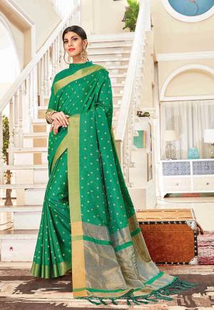 Flaunt Your Rich And Elegant Taste In Silk With This Subtle Weaved Saree In Green Color. This Saree And Blouse Are Fabricated On Art Silk Beautified With Pretty Small Butti Weave All Over It. Its Silk Based Fabric Will Give A Rich Look To Your Personality.