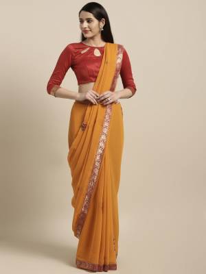 Celebrate This Festive Season With Beauty And Comfort Wearing This Light Weight Saree In Musturd Yellow Color Paired With Contrasting Red Colored Blouse. This Saree Is Chiffon Based Paired With Art Silk Fabricated Blouse. 
