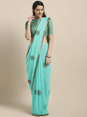 Look Pretty In This Beautiful Small Motif Embroidered Saree In Aqua Blue Color Paired With Green Colored Blouse. This Saree Is Fabricated On Chiffon Paired With Art Silk Fabricated Blouse. It Is Light In Weight And Easy To Carry All Day Long. 