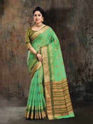 Go With The Shades Of Green With This Silk Based Saree In Green Color Paired With Olive Green Colored Blouse. This Saree And Blouse Are Fabricated On Art Silk Beautified With Weave All Over It.