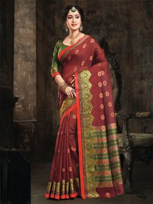 Adorn A Royal Look In This Designer Silk Based Saree In Maroon Color Paired With Contrasting Green Colored Blouse. This Saree And Blouse Are Fabricated On Art Silk Beautified With Weave All Over It. 