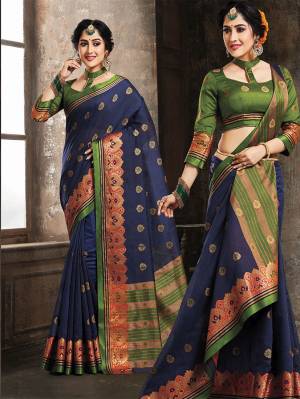 Enhance Your Personality Wearing This Rich Designer Silk Based Saree In Navy Blue Color Paired With Contrasting Dark Green Colored Blouse. Its Fabric Ensures Superb Comfort And Also It Is Durable.
