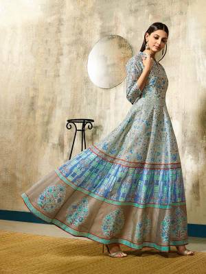 Add This Beautiful Printed Gown To Your Wardrobe In Light Blue Color Fabricated On Chanderi. This Readymade Gown Is Available In All Sizes, Choose As Per Your Desired Fit And Comfort. 
