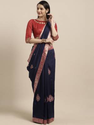 Enhance Your Personality Wearing This Designer Saree In Navy Blue Color Paired With Contrasting Red Colored Blouse. This Saree And Blouse Are Silk Based Beautified With Weave Lace Border And Embroiderd Butti. 
