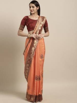 This Festive Season Have A Proper Traditonal Look With This Silk Based Embroidered Saree. This Saree Is In Light Orange Color Paired With Contrasting Maroon Colored Blouse. It Is Beautified With Lace Border & Embroidered Butti.