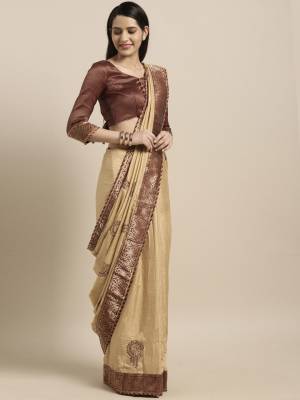Add Thid Pretty Designer Silk Based Saree To Your Wardrobe In Cream Color Paired With Contrasting Brown Colored Blouse. Its Silk Fabric Will Give A Rich Look To Your Personality. 