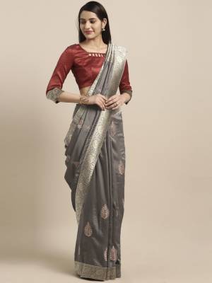 Grab This Pretty Silk Based Saree In Grey Color Paired With Contrasting Maroon Colored Blouse. Its Rich Silk Fabric Is Light In Weight And Easy To Carry All Day Long, Also It Is Durable And Easy To Care For. 