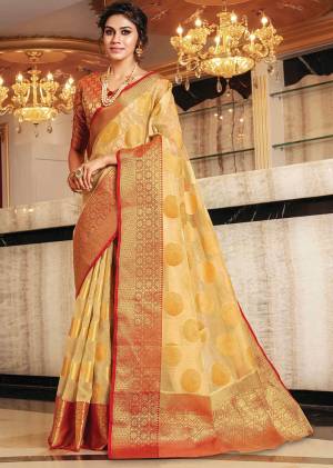 Catch All The Limelight At The Next Function You Attend Wearing This Silk Based Saree In Beige Color Paired With Contrasting Orange Colored Blouse. Its Rich Handloom Art Silk Fabric Will Give A Royal Look To Your Personality