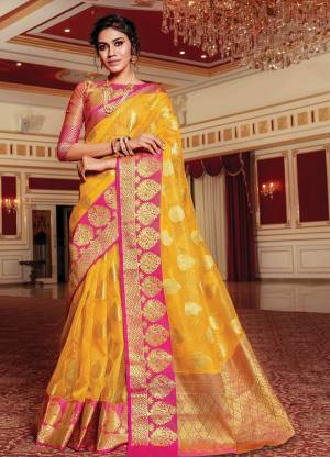 Celebrate This Festive Season With Beauty And Comfort Wearing This Designer Saree In Yellow Color Paired With Contrasting Pink Colored Blouse. This Saree And Blouse Are Fabricated On Handloom Art Silk Beautified With Weave All Over. It Is Light Weight And Easy To Drape.