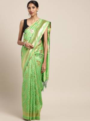 Celebrate This Festive Season In Traditional Look Wearing This Silk?Based Saree In Green Color. This Saree And Blouse are Fabricated On Banarasi Art Silk Beautified With Weave All Over