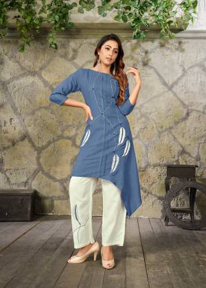 Here Is A Pretty Pair Of Kurti And Pant For Your Semi-Casual Or Festive Wear. Its Assymetric Patterned Kurti Is In Blue Color Paired With White Colored Bottom. This Readymade Pair Is Fabricated On Rayon Beautified With Thread Work. 