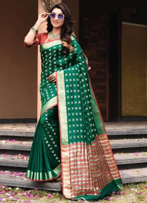 Add This Pretty Simple And Elegant Looking Silk Based Saree In Dark Green Color Paired With Contrasting Red Colored Blouse. This Saree And Blouse Are Fabricated On Art Silk Beautified With Weave All Over. 