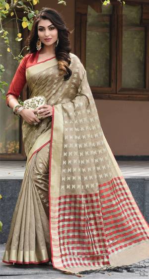 Add This Pretty Simple And Elegant Looking Silk Based Saree In Beige Color Paired With Contrasting Red Colored Blouse. This Saree And Blouse Are Fabricated On Art Silk Beautified With Weave All Over. 