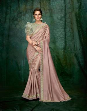 A gorgeous Dusty combination saree enhanced with ruffle and frill details topped with hand embroidery is all about expressing your feminine personality in details.