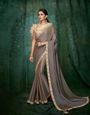 Break away from the monotony and drape this new-age saree with westernised touch to the blouse and English hues . 