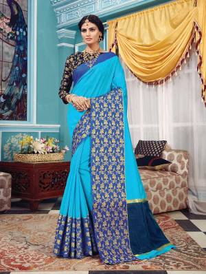 Here Is A Pretty Silk Based Saree In Same Family Color Saree And Blouse. This Pretty Saree Is In Blue Color Paired With Navy Blue Colored Blouse. It Is Beautified With Weave Over The Broad Saree Border Giving It An Attractive Look. 