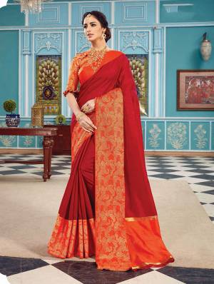 Here Is A Pretty Silk Based Saree In Same Family Color Saree And Blouse. This Pretty Saree Is In Red Color Paired With Orange Colored Blouse. It Is Beautified With Weave Over The Broad Saree Border Giving It An Attractive Look. 