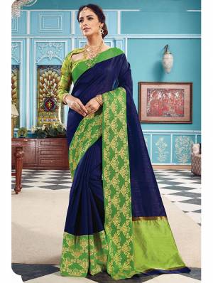 Here Is A Pretty Silk Based Saree In Same Family Color Saree And Blouse. This Pretty Saree Is In Navy Blue Color Paired With Green Colored Blouse. It Is Beautified With Weave Over The Broad Saree Border Giving It An Attractive Look. 