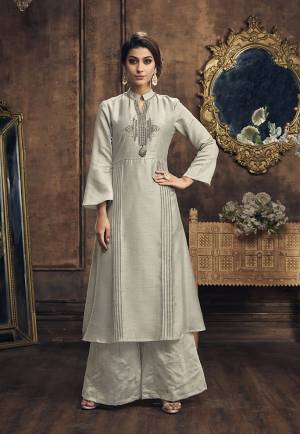 Flaunt Your Rich And Elegant Taste In This Beautiful Designer Grey Colored Kurti Paired With Grey Colored Bottom. This Readymade Pair Is Fabricated On Soft silk Beautified With Foil Prints And Embroidery. 