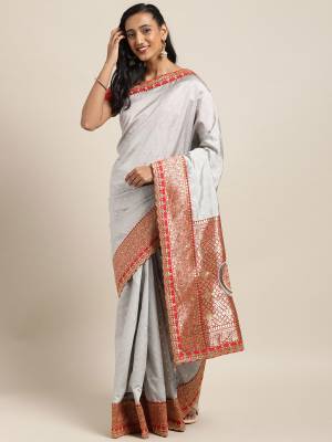 Grab This Beautiful Designer Saree In Grey Color Paired With Red Colored Blouse. This Pretty Saree And Blouse are Fabricated On Art Silk Highlited With Jacquard Silk Pallu. Its Blouse Is Beautified With Heavy Embroidery And Weave Over The Saree. 