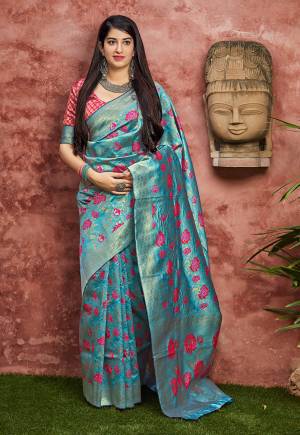 Grab This Pretty Silk Based Saree For The Upcoming Festive And Wedding Season In Blue Color Paired With Contrasting Dark Pink Colored Blouse. This Saree And Blouse Are Fabricated On Banarasi Art Silk Beautified With Weave All Over. 