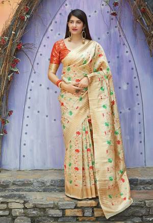 Flaunt Your Rich And Elegant Taste In This Silk Based Designer Saree In Cream Color Paired With Orange Colored Blouse. This Saree And Blouse Are Fabricated On Banarasi Art Silk Beautified With Weave. Its Rich Fabric And Color Will Give A Look Like Never Before. 