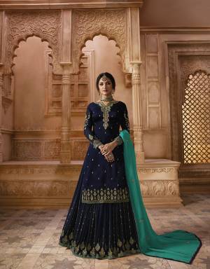 Go With The Shades Of Blue Wearing This Designer Heavy Sharara Suit In Navy Blue Color Paired With Turquoise Blue Colored Dupatta. Its Top Is Fabricated On Satin Georgette Paired With Georgette Sharara Ans Dupatta And Also With A Santoon Fabricated Bottom, So You Can Wear It Two Ways, Either With Sharara Or Bottom. 