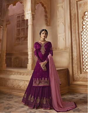 Celebrate This Festive Season Wearing This Heavy Designer Sharara Suit In Magenta Pink Colored Top Paired With Magenta Pink Colored Sharara And Bottom And Also It Comes With A Pink Colored Dupatta. Its Embroidered Top IS Fabricated on Satin Georgette Paired With  Embroidered Georgette Sharara And Dupatta. 