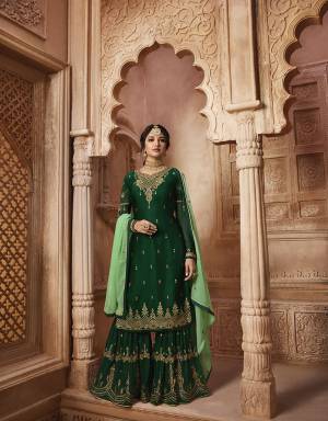 Go With The Shades Of Green Wearing This Designer Heavy Sharara Suit In Dark Green Color Paired With Light Green Colored Dupatta. Its Top Is Fabricated On Satin Georgette Paired With Georgette Sharara Ans Dupatta And Also With A Santoon Fabricated Bottom, So You Can Wear It Two Ways, Either With Sharara Or Bottom. 