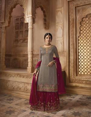 Look Beautiful Wearing This Heavy Designer Sharars Suit In Sand Grey Colored Top Paired With Contrasting Maroon Colored Sharara And Dupatta And Another Bottom In Sand Grey Color. Its Top Is Fabricated On Satin Georgette Paired With Two Bottoms In Georgette Sharara And Santoon Bottom. Its Beautiful Color Pallete And Heavy Embroidery Will Definitely Earn You Lots Of Compliments From Onlookers. 