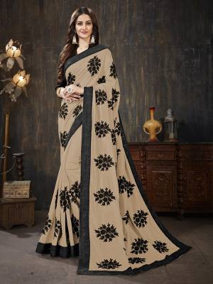 Here Is A Very Pretty Designer Silk Based Saree In Beige Color Paired With Black Colored Blouse. It Is Beautified With Black Colored Thread Work Motifs All Over. Also It Is Light In Weight And Easy To Carry Throughout The Gala. Buy Now.