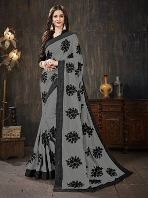 Here Is A Very Pretty Designer Silk Based Saree In Grey Color Paired With Black Colored Blouse. It Is Beautified With Black Colored Thread Work Motifs All Over. Also It Is Light In Weight And Easy To Carry Throughout The Gala. Buy Now.