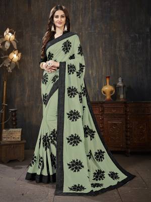 Here Is A Very Pretty Designer Silk Based Saree In Pastel Green Color Paired With Black Colored Blouse. It Is Beautified With Black Colored Thread Work Motifs All Over. Also It Is Light In Weight And Easy To Carry Throughout The Gala. Buy Now.
